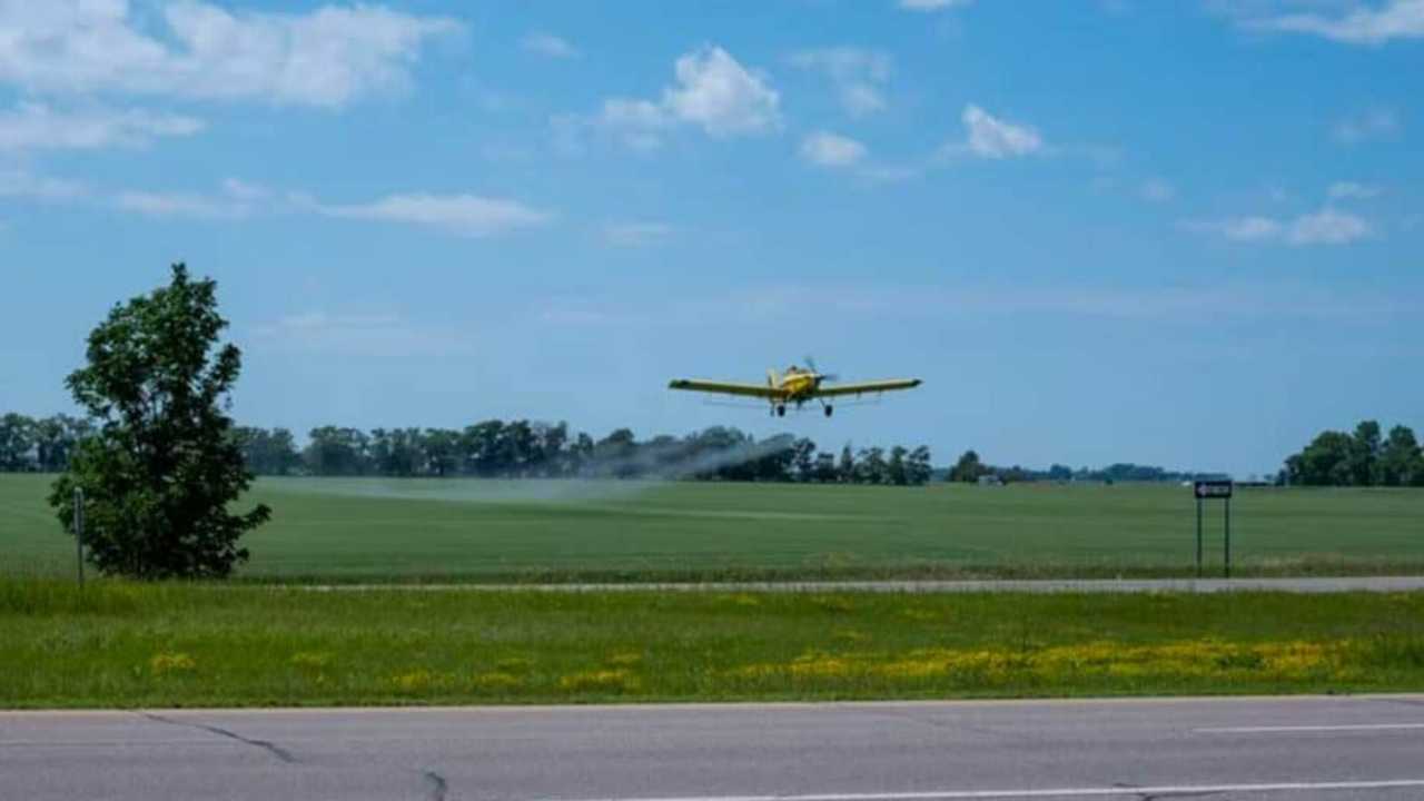 crop duster is flying over property