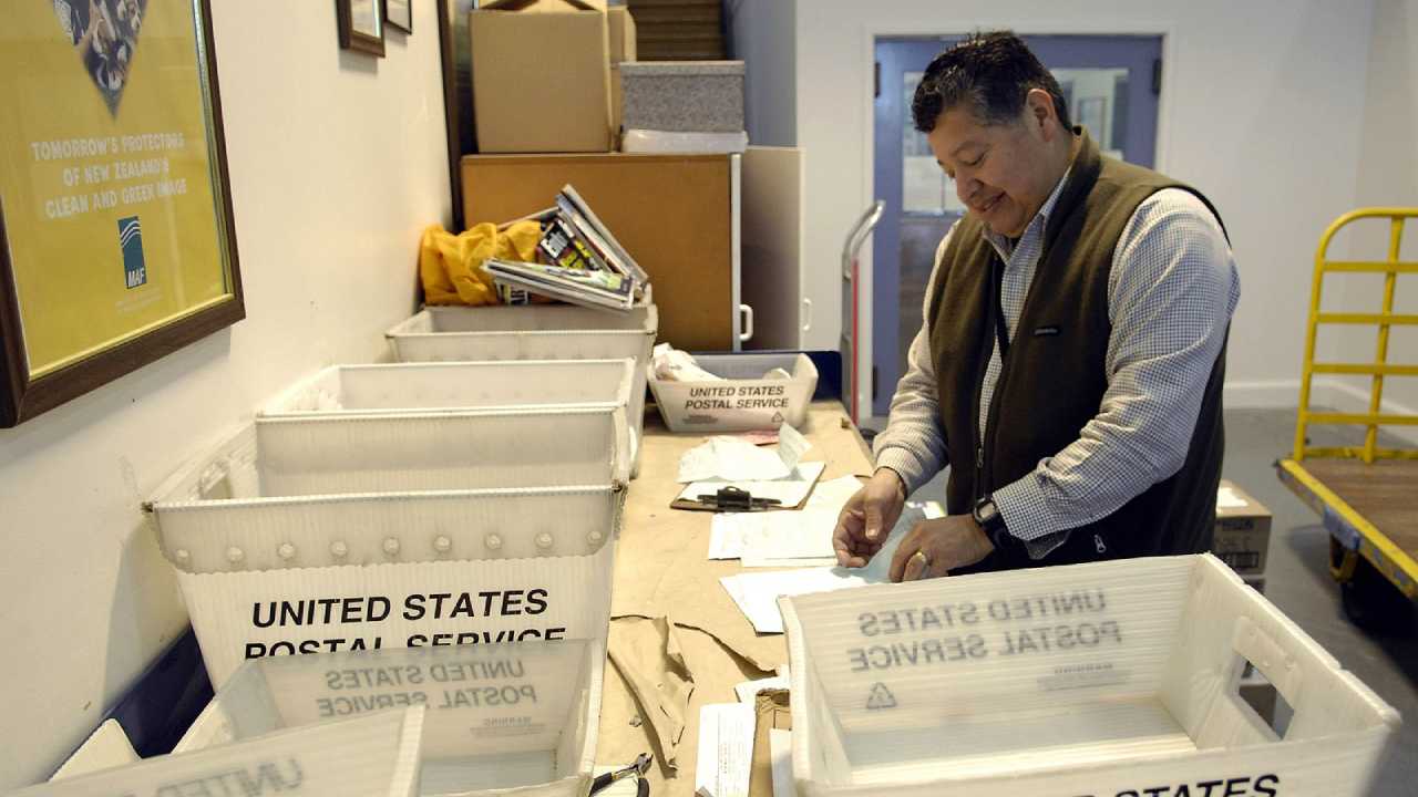 mailman sorting tubs in post office
