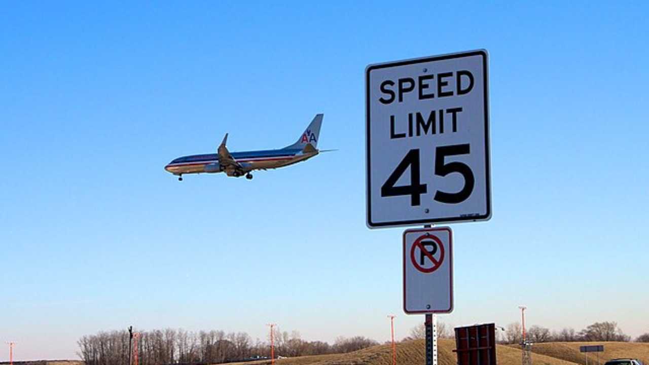 speed limit sign with plane